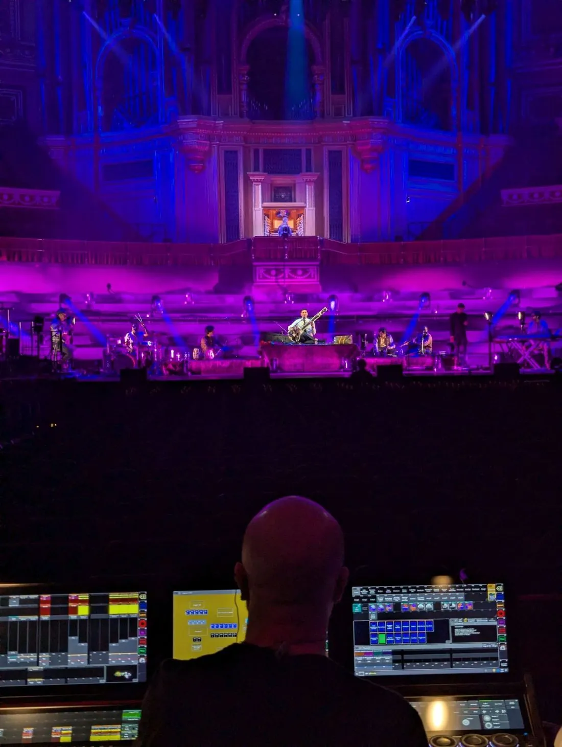 Rishab Rikhiram Sharma's band at the Royal Albert Hall seen over the lighting operator's desk, organ lit purple